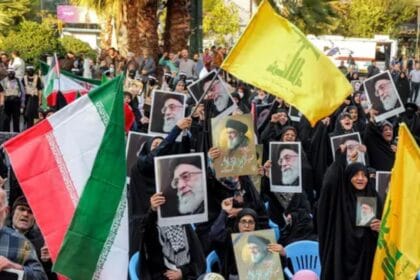 Protesters in Tehran wave Iranian flags, Hezbollah flags, and hold images of Supreme Leader Ayatollah Ali Khamenei during an anti-Israel rally on October 24, 2024.