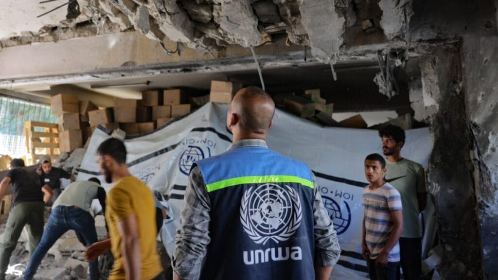 An UNRWA staff member and displaced Palestinians assess the damage inside a UN school converted into a shelter at al-Shati refugee camp, near Gaza City, Gaza Strip, on October 19, 2024.