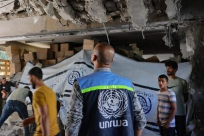 An UNRWA staff member and displaced Palestinians assess the damage inside a UN school converted into a shelter at al-Shati refugee camp, near Gaza City, Gaza Strip, on October 19, 2024.